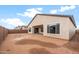 New backyard with covered patio and block wall at 16679 W Saguaro Park Ln, Surprise, AZ 85387