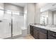 Bright bathroom featuring a walk-in shower with a glass door at 16679 W Saguaro Park Ln, Surprise, AZ 85387