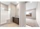 Bright bathroom featuring a shower and vanity with granite countertop at 16679 W Saguaro Park Ln, Surprise, AZ 85387