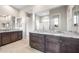Bright bathroom featuring double vanity with granite countertops at 16679 W Saguaro Park Ln, Surprise, AZ 85387