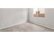A carpeted bedroom with natural light from the window at 16679 W Saguaro Park Ln, Surprise, AZ 85387