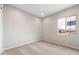 A carpeted bedroom featuring a view through the window at 16679 W Saguaro Park Ln, Surprise, AZ 85387