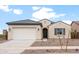 Charming single-story home featuring a two-car garage and low-maintenance landscaping at 16679 W Saguaro Park Ln, Surprise, AZ 85387