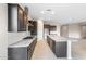 Modern kitchen with dark cabinetry, stainless steel appliances, and granite countertops at 16679 W Saguaro Park Ln, Surprise, AZ 85387