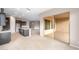 Open floor plan with kitchen island, dark cabinets, and sliding glass door to patio at 16679 W Saguaro Park Ln, Surprise, AZ 85387