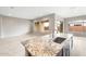 Kitchen island with granite countertop and stainless sink and faucet at 16679 W Saguaro Park Ln, Surprise, AZ 85387