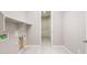 A functional laundry room area with tile floors and convenient utility connections at 16679 W Saguaro Park Ln, Surprise, AZ 85387