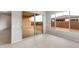 Living area with a sliding glass door, a large window, and beige tile floors at 16679 W Saguaro Park Ln, Surprise, AZ 85387