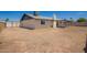 A expansive backyard showcasing a freshly painted home with ample outdoor space and bright blue sky at 17040 N 39Th Ave, Glendale, AZ 85308