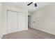 This bedroom features carpet floors and a closet with sliding doors for convenient storage at 17040 N 39Th Ave, Glendale, AZ 85308
