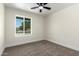 This carpeted bedroom features a bright window and a ceiling fan for added comfort at 17040 N 39Th Ave, Glendale, AZ 85308
