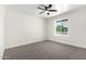 This bedroom has plush carpet, a modern ceiling fan, and a window with a view at 17040 N 39Th Ave, Glendale, AZ 85308