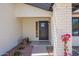 Exterior entrance with black door, white brick column, and seating at 17040 N 39Th Ave, Glendale, AZ 85308