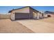 Single-story home featuring a gravel yard, gray garage door, and modern architecture under a clear sky at 17040 N 39Th Ave, Glendale, AZ 85308