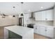 Modern kitchen features white cabinets, stainless steel appliances, kitchen island and pendant lighting at 17040 N 39Th Ave, Glendale, AZ 85308