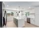 Bright kitchen showcasing a kitchen island with seating, stainless appliances, and outside views at 17040 N 39Th Ave, Glendale, AZ 85308