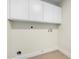 A functional laundry room with ample cabinet space and utility connections at 17040 N 39Th Ave, Glendale, AZ 85308