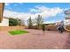 Large gravel backyard featuring an open space and a patch of green lawn, perfect for outdoor activities at 18096 N Arbor Dr, Maricopa, AZ 85138