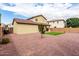Expansive backyard with low-maintenance gravel, lush green lawn, young tree, and a view of the home's rear exterior at 18096 N Arbor Dr, Maricopa, AZ 85138