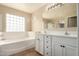 Bathroom with a tub, tile flooring, and double vanity at 18096 N Arbor Dr, Maricopa, AZ 85138