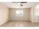 Neutral bedroom space with hardwood floors, window, and ceiling fan at 18096 N Arbor Dr, Maricopa, AZ 85138