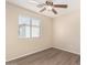 Bedroom featuring wood-look floors and a large window with blinds at 18096 N Arbor Dr, Maricopa, AZ 85138