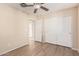 Bedroom with wood-look floors, ceiling fan, closet, and ensuite bathroom at 18096 N Arbor Dr, Maricopa, AZ 85138