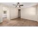 Bedroom showing wood-look floors, ceiling fan, ensuite bathroom and walk-in closet at 18096 N Arbor Dr, Maricopa, AZ 85138