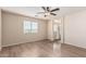 Bedroom featuring wood-look floors and an ensuite bathroom with glass shower at 18096 N Arbor Dr, Maricopa, AZ 85138