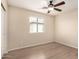 This bedroom features sleek flooring, a ceiling fan, and a window with blinds at 18096 N Arbor Dr, Maricopa, AZ 85138