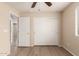 This bedroom has wood-look flooring, a ceiling fan, and a sliding door closet at 18096 N Arbor Dr, Maricopa, AZ 85138