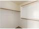 Walk-in closet featuring wood floors and white shelves at 18096 N Arbor Dr, Maricopa, AZ 85138