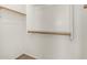 Walk-in closet with simple wooden shelves and racks; wood-look floors at 18096 N Arbor Dr, Maricopa, AZ 85138