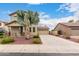 Charming two-story home featuring desert landscaping, a long driveway, and a detached garage, capturing curb appeal at 18096 N Arbor Dr, Maricopa, AZ 85138