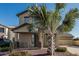 Charming home featuring desert landscaping, a quaint front porch, and a two-car garage at 18096 N Arbor Dr, Maricopa, AZ 85138