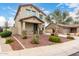 Inviting two-story home with desert landscaping showcasing a covered porch and natural stone accents on the facade at 18096 N Arbor Dr, Maricopa, AZ 85138