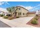 Suburban home with well-maintained landscaping, a detached garage, and a spacious driveway, providing ample parking at 18096 N Arbor Dr, Maricopa, AZ 85138