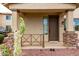 Inviting front porch with stone accents and desert landscaping, enhancing the home's entrance and curb appeal at 18096 N Arbor Dr, Maricopa, AZ 85138