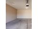 Spacious two car garage with concrete floors and overhead lighting at 18096 N Arbor Dr, Maricopa, AZ 85138
