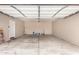 Spacious garage with ample room for storage, concrete floors, and an entrance door at 18096 N Arbor Dr, Maricopa, AZ 85138