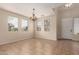 Bright living room featuring tile flooring, a decorative chandelier, and large windows allowing ample natural light at 18096 N Arbor Dr, Maricopa, AZ 85138