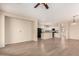 Bright, open-concept living area connected to a kitchen with a ceiling fan at 18096 N Arbor Dr, Maricopa, AZ 85138