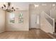 Spacious living room featuring tile flooring, a staircase, and large windows allowing ample natural light at 18096 N Arbor Dr, Maricopa, AZ 85138
