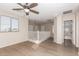 Open loft area with wood-look floors, bright natural light, and open railing at 18096 N Arbor Dr, Maricopa, AZ 85138