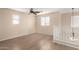 Cozy loft area with hardwood floors and ample natural light from multiple windows at 18096 N Arbor Dr, Maricopa, AZ 85138