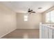 Neutral loft space featuring hardwood floors, ceiling fan, and natural light at 18096 N Arbor Dr, Maricopa, AZ 85138