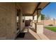 Covered patio space with sturdy column supports and access to the backyard at 18096 N Arbor Dr, Maricopa, AZ 85138