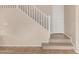 Staircase featuring white railings and light brown flooring, leading to the upper level at 18096 N Arbor Dr, Maricopa, AZ 85138