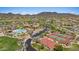 Scenic aerial view of neighborhood amenities including a pool, tennis courts, and lush landscaping with mountain backdrop at 1915 N Bernard Cir, Mesa, AZ 85207