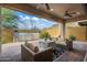 Inviting covered patio features a fire pit and cozy outdoor seating area at 1915 N Bernard Cir, Mesa, AZ 85207